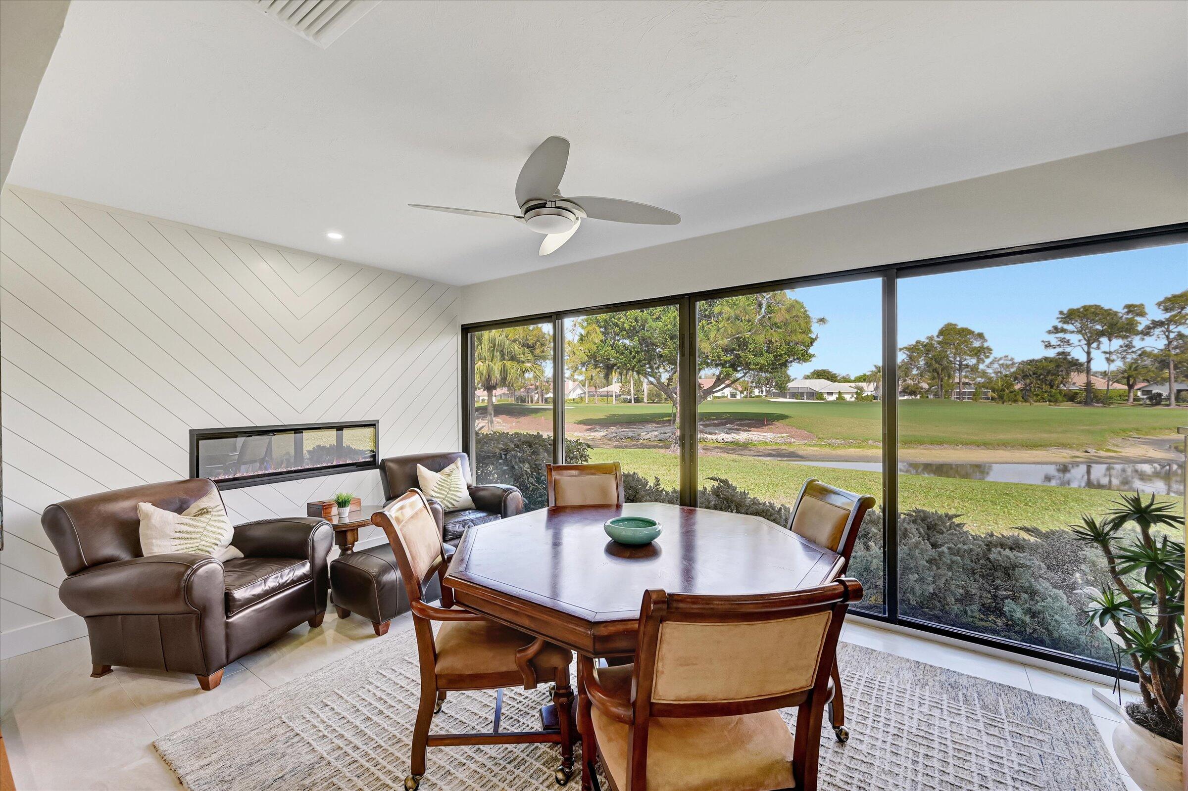 535 Augusta Boulevard, Unit 4 Naples, FL 34113 - Photo 28 of 44 a living room with furniture and a floor to ceiling window