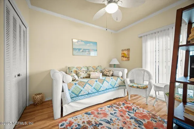 a bedroom with furniture and a painting on the wall