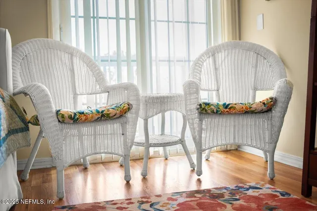 a spacious bedroom with a bed a dresser and a large window
