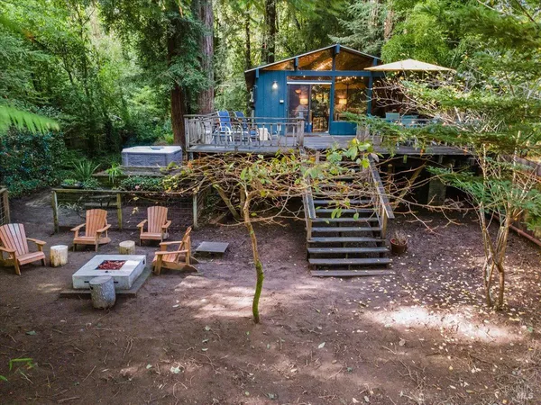 a view of a chairs and table in backyard