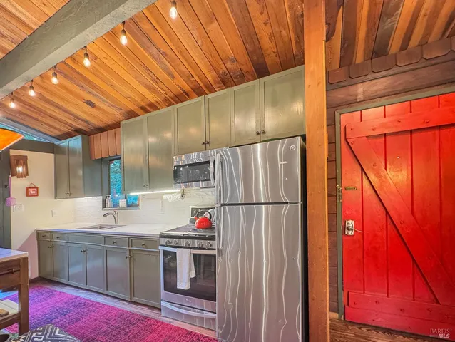 a kitchen with refrigerator and cabinets