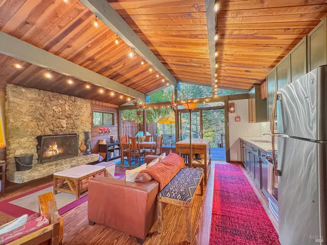 a living room with furniture a fireplace and a table