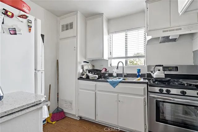 a bedroom with a bed a window and dresser