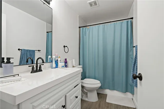 an aerial view of a house with a yard and large trees