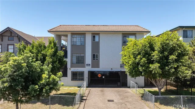 a front view of a house with trees