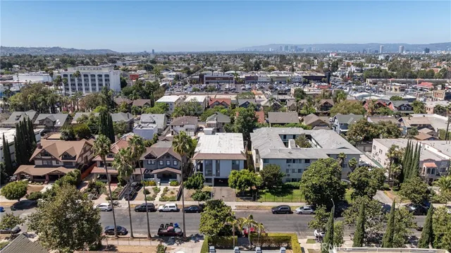 an aerial view of residential houses with city view