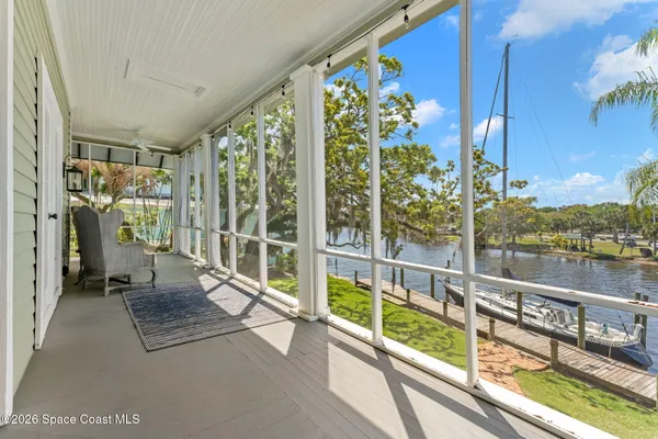 a dining room with furniture a rug and wooden floor