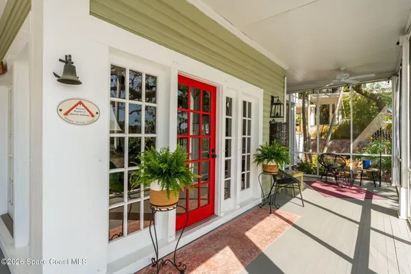 a room with stainless steel appliances kitchen island granite countertop a table chairs and a living room view