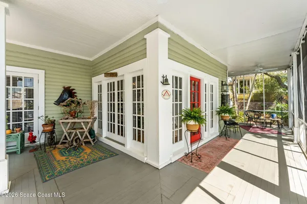 a kitchen with stainless steel appliances granite countertop a stove and a view of living room