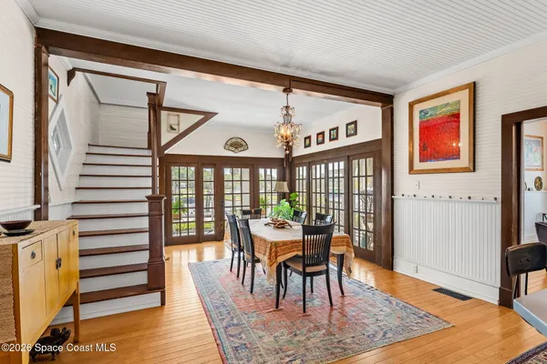 a view of a dining room with furniture and floor to ceiling window