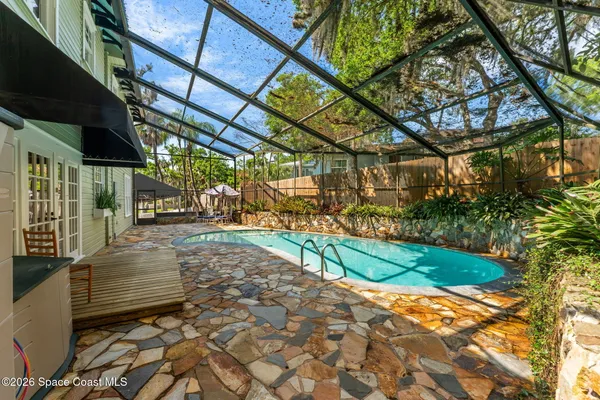 an aerial view of residential houses with outdoor space and lake view