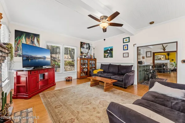 a front view of a house with a yard and potted plants