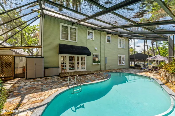 a view of living room with furniture and floor to ceiling window