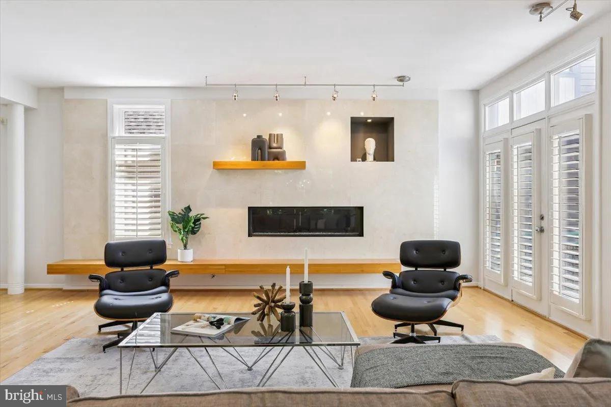 1460 Waterfront Road Reston, VA 20194 - Photo 14 of 59 a living room with furniture a rug and a floor to ceiling window