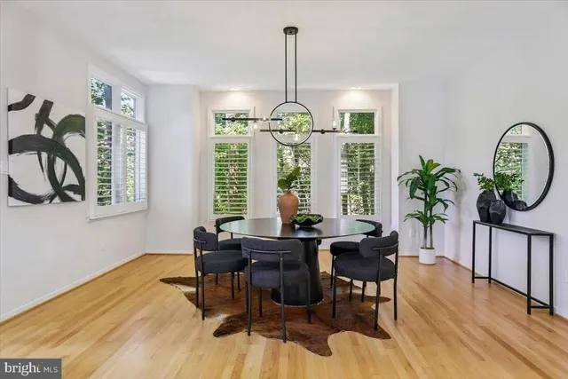 a view of a dining room with a table and chairs