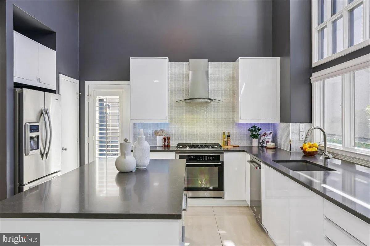 1460 Waterfront Road Reston, VA 20194 - Photo 19 of 59 a kitchen with stainless steel appliances granite countertop a sink stove and refrigerator