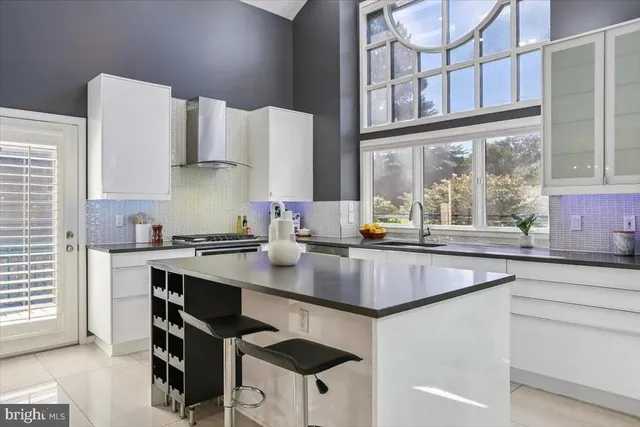 a kitchen with stainless steel appliances granite countertop a sink a stove and a refrigerator