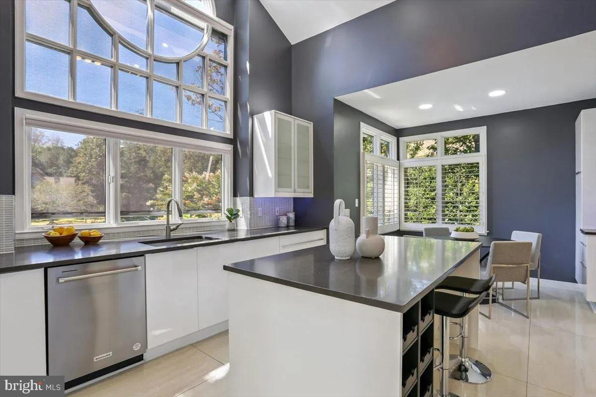 1460 Waterfront Road Reston, VA 20194 - Photo 21 of 59 a kitchen with a sink window and chairs