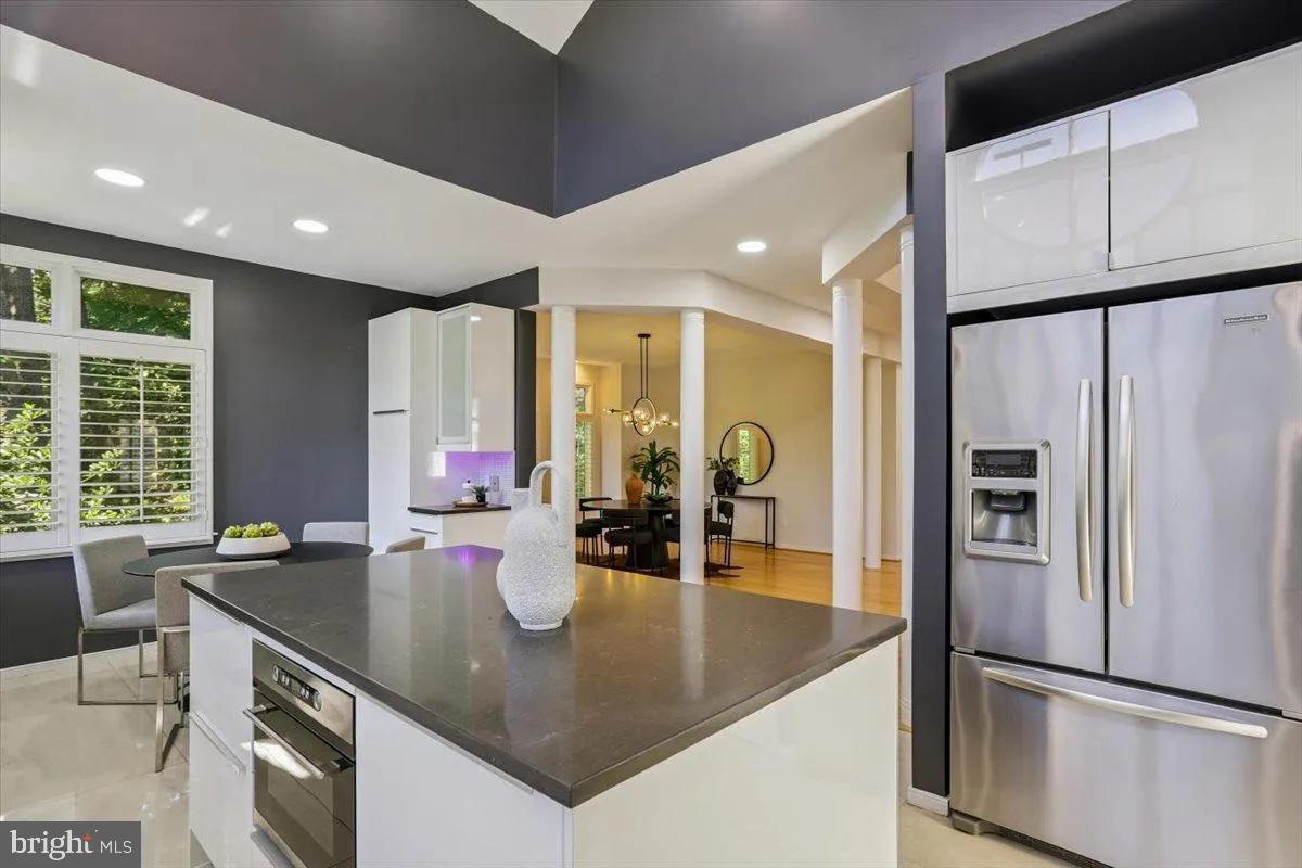 1460 Waterfront Road Reston, VA 20194 - Photo 22 of 59 a kitchen with stainless steel appliances granite countertop a sink a stove and a refrigerator