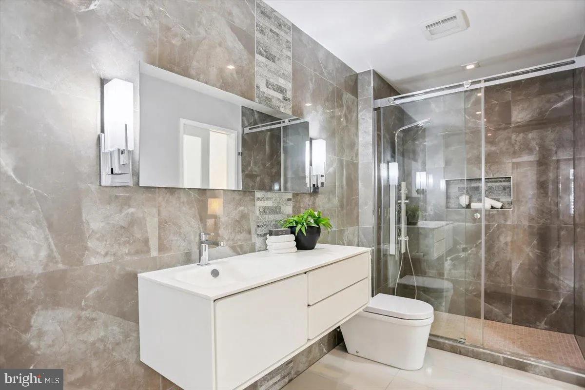 1460 Waterfront Road Reston, VA 20194 - Photo 25 of 59 a bathroom with a sink a toilet and shower