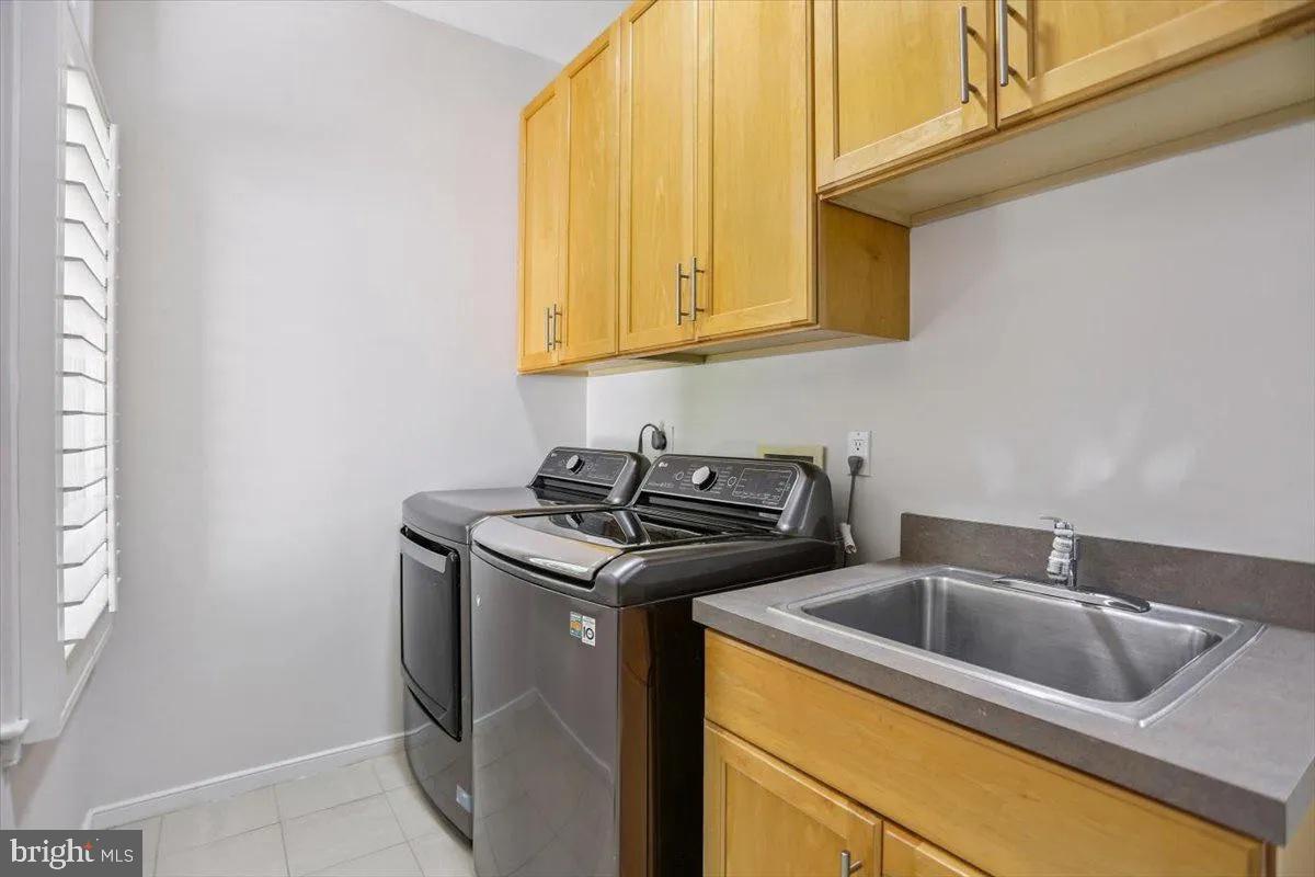 1460 Waterfront Road Reston, VA 20194 - Photo 27 of 59 a kitchen with stainless steel appliances granite countertop a sink and cabinets