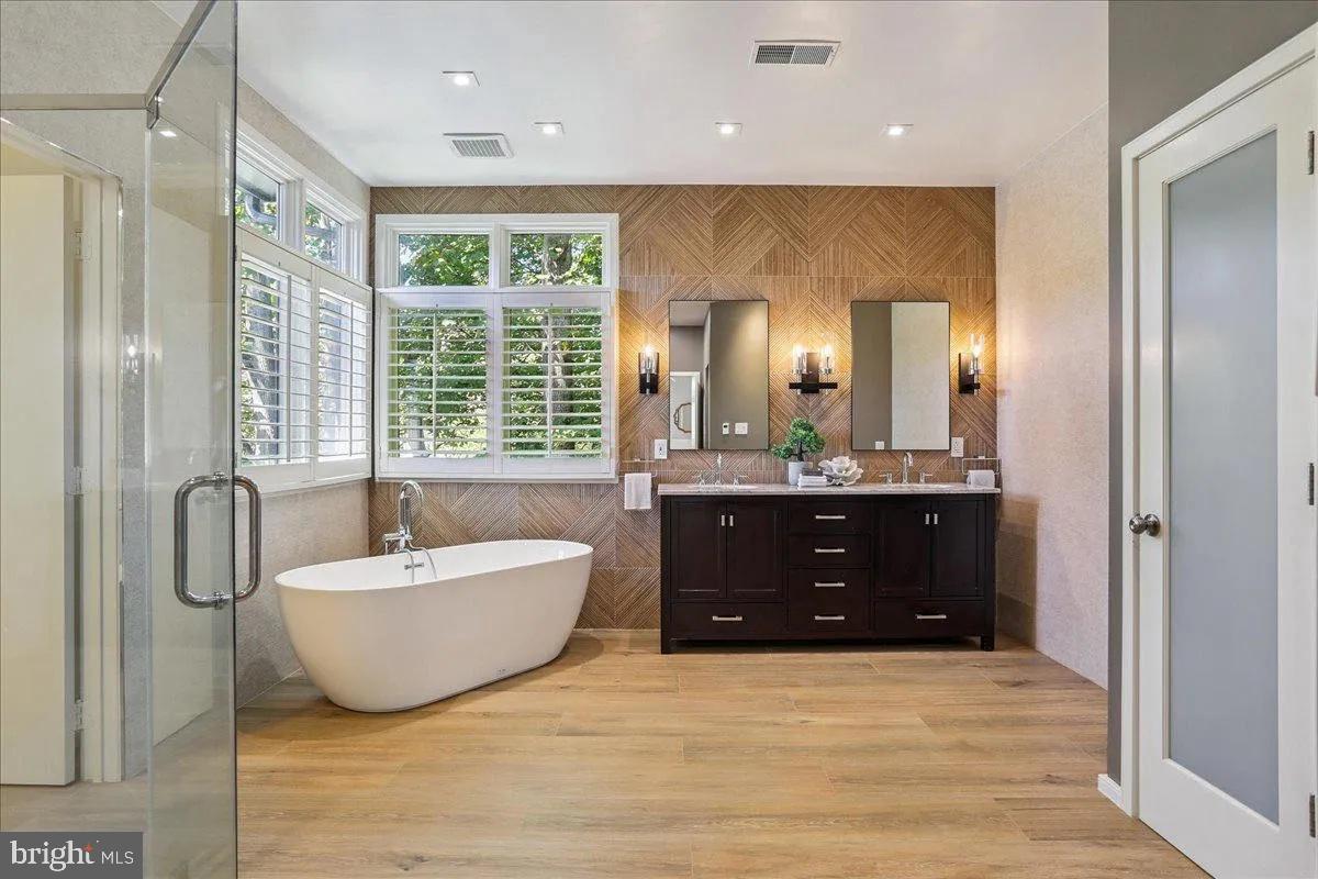 1460 Waterfront Road Reston, VA 20194 - Photo 30 of 59 a spacious bathroom with a tub sink shower and mirror