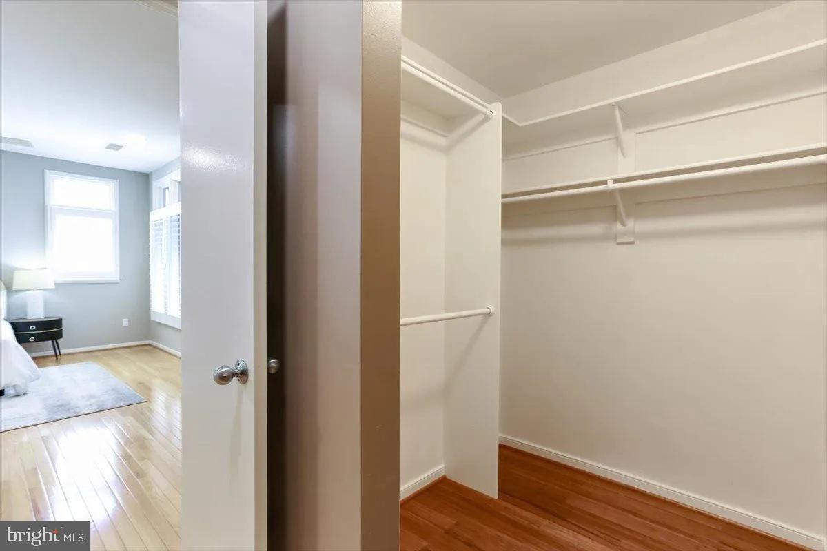 1460 Waterfront Road Reston, VA 20194 - Photo 33 of 59 a view of a bedroom with wooden floor and closet