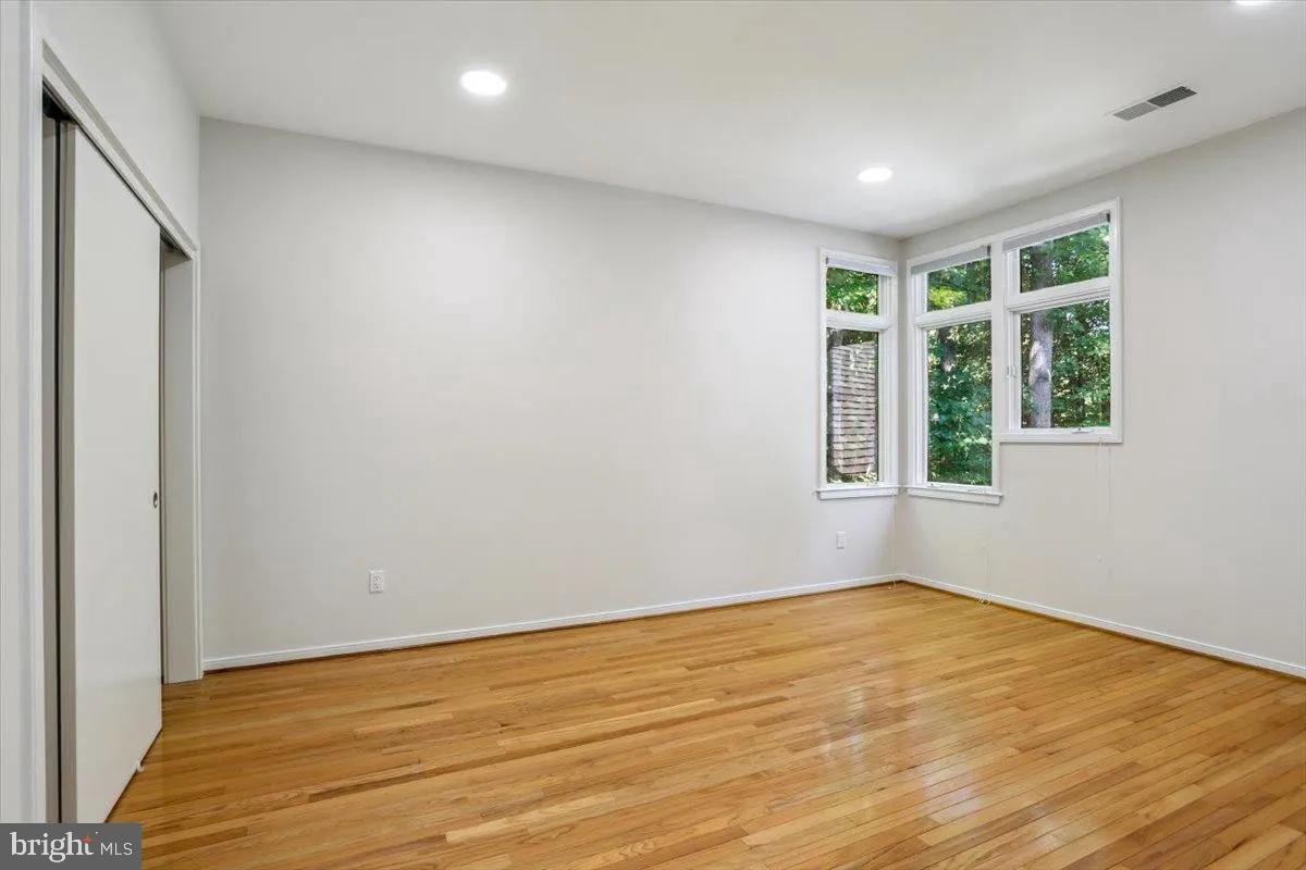 1460 Waterfront Road Reston, VA 20194 - Photo 34 of 59 a view of an empty room with wooden floor and a window