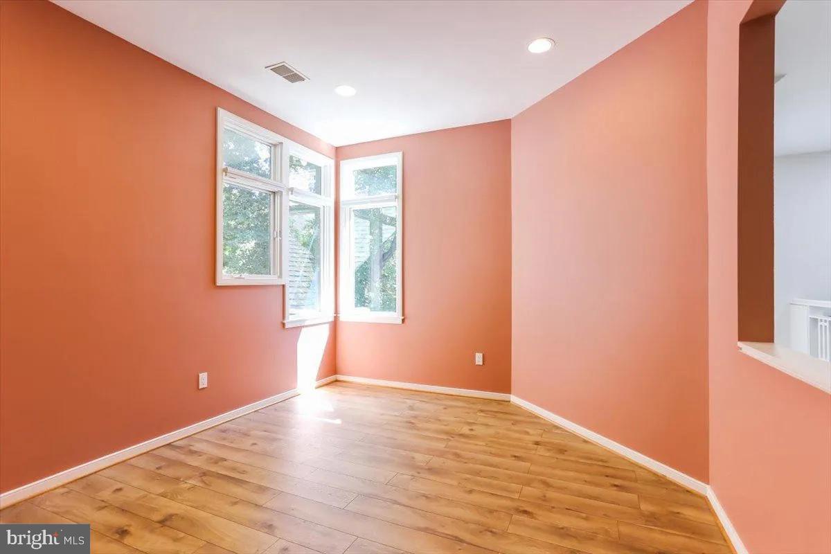1460 Waterfront Road Reston, VA 20194 - Photo 35 of 59 a view of an empty room with wooden floor and a window