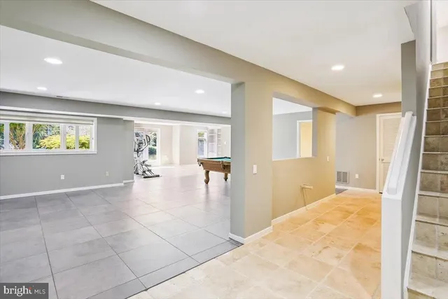 a room with pool table and windows