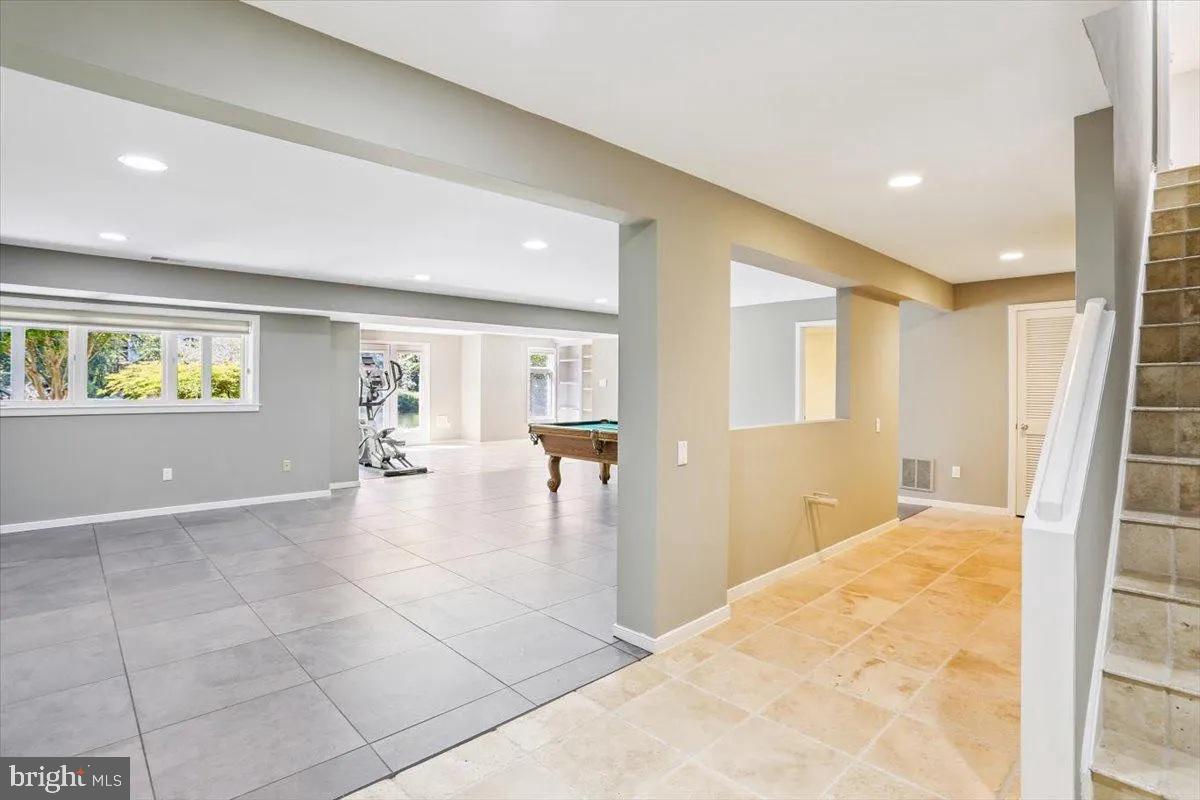 1460 Waterfront Road Reston, VA 20194 - Photo 39 of 59 a view of a hallway with wooden floor and a living room