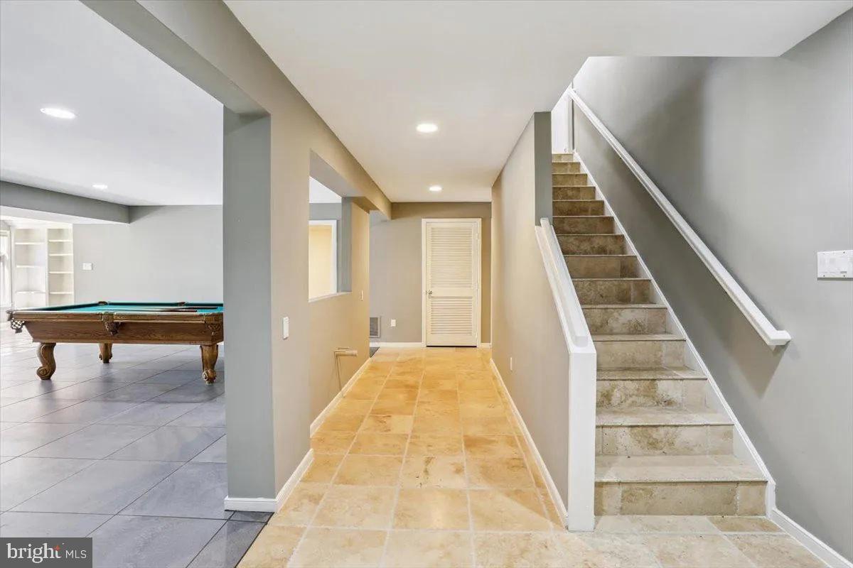 1460 Waterfront Road Reston, VA 20194 - Photo 40 of 59 a view of staircase with lots of frames on wall and a large window