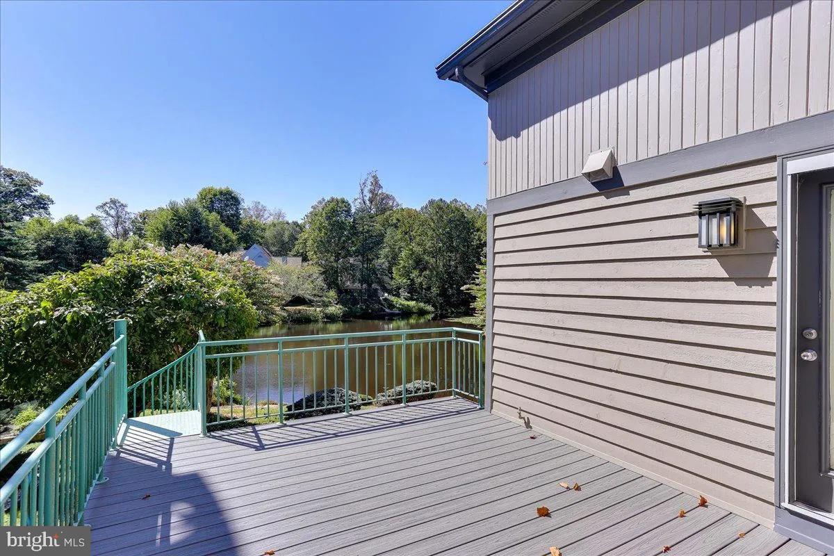 1460 Waterfront Road Reston, VA 20194 - Photo 51 of 59 a view of a roof deck with wooden floor and fence