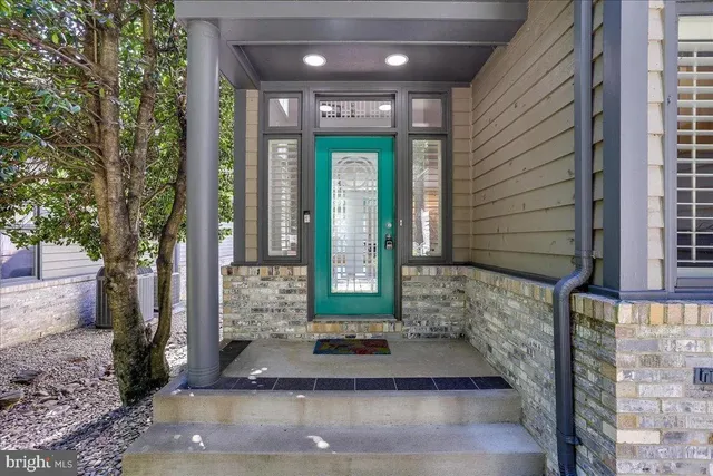 a view of a bedroom with a bed and wooden floor