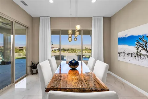 a view of kitchen island with stainless steel appliances granite countertop a sink and a wooden floor