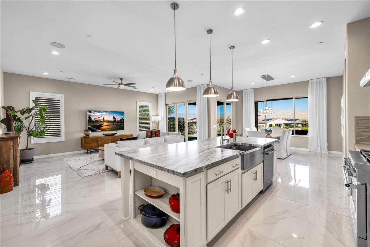 97 Zinfandel Rancho Mirage, CA 92270 - Photo 18 of 68 a view of kitchen island with stainless steel appliances granite countertop a sink and a wooden floor