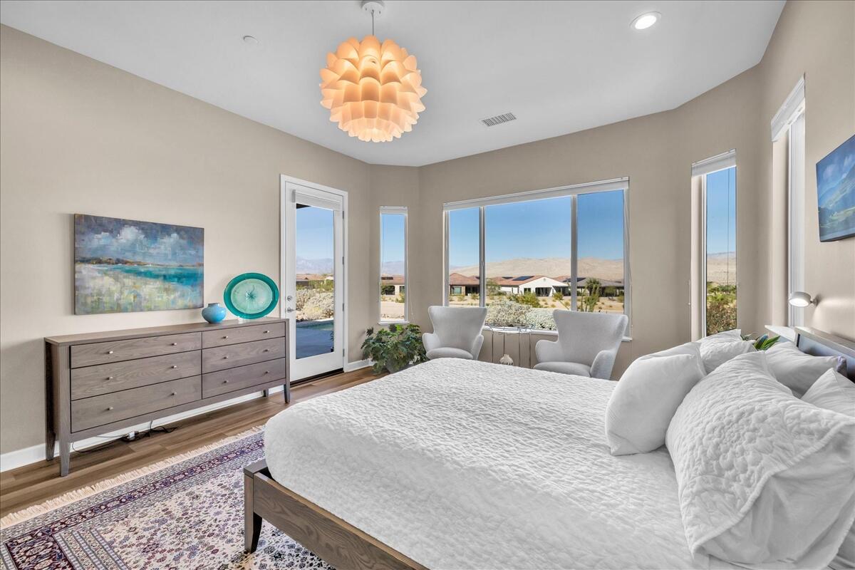 97 Zinfandel Rancho Mirage, CA 92270 - Photo 23 of 68 a bedroom with a bed and a chandelier