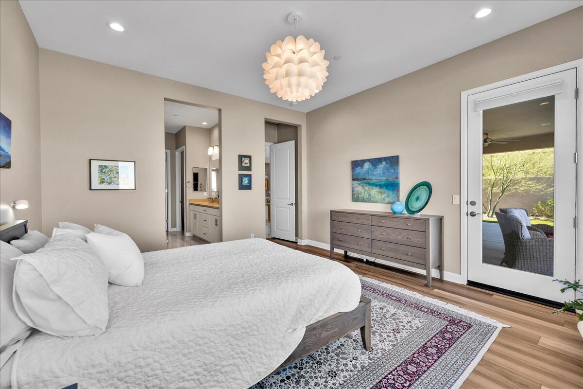 97 Zinfandel Rancho Mirage, CA 92270 - Photo 24 of 68 a bedroom with a bed and a chandelier