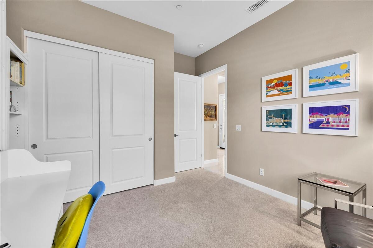 97 Zinfandel Rancho Mirage, CA 92270 - Photo 26 of 50 a bed room with a bed and a painting on the wall