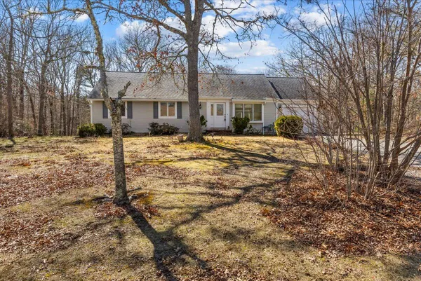 a front view of a house with a yard covered in snow