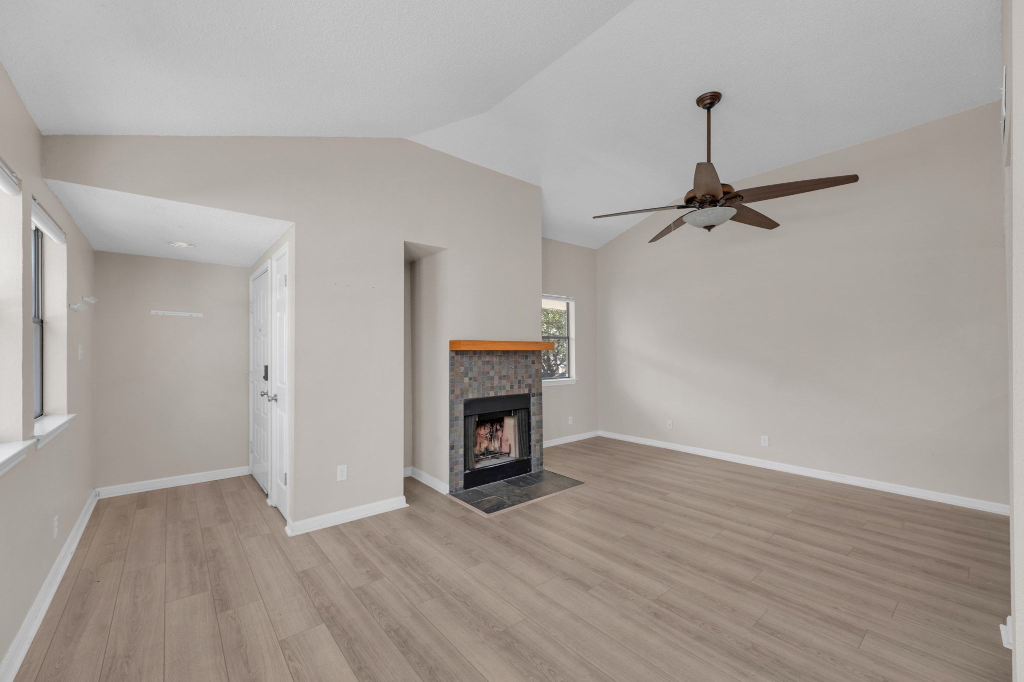 9226 Jollyville Road, Unit 280 Austin, TX 78759 - Photo 8 of 26 Open concept living area with vaulted ceilings and a charming fireplace that adds warmth and personality to the space.