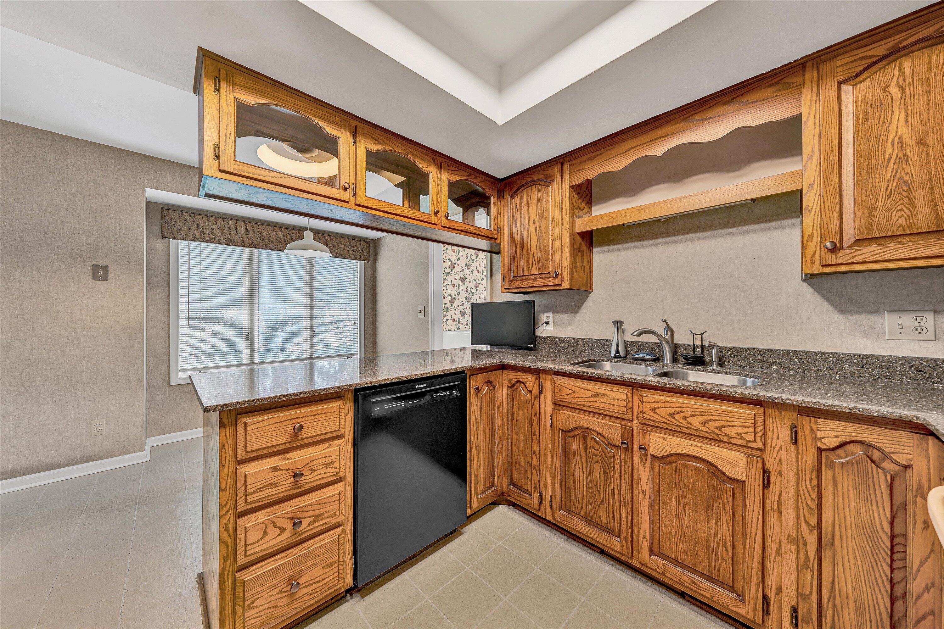 3318 One Oak Road Roanoke, VA 24018 - Photo 14 of 43 a kitchen with stainless steel appliances granite countertop a sink and cabinets