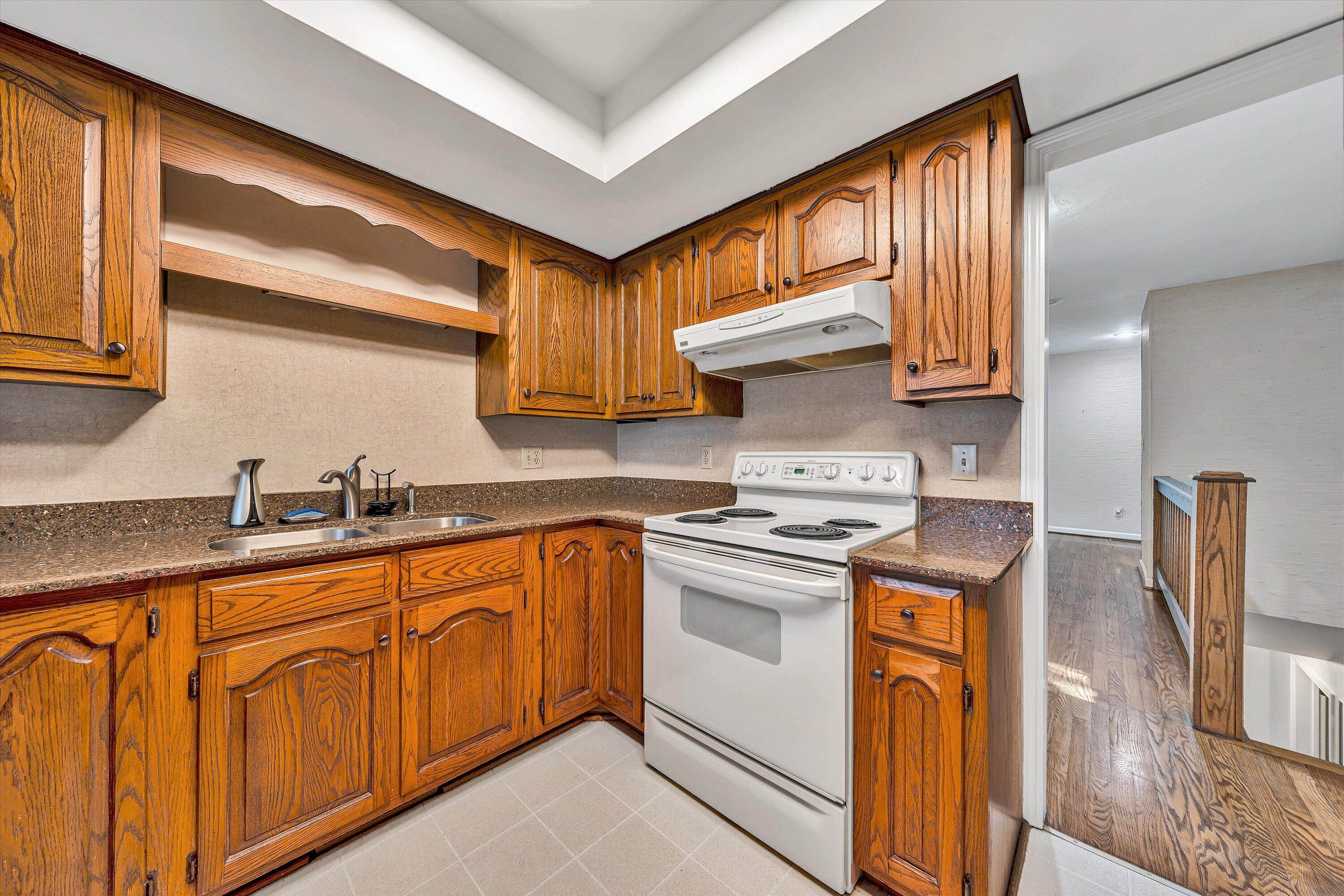 3318 One Oak Road Roanoke, VA 24018 - Photo 15 of 43 a kitchen with granite countertop a sink a stove and cabinets