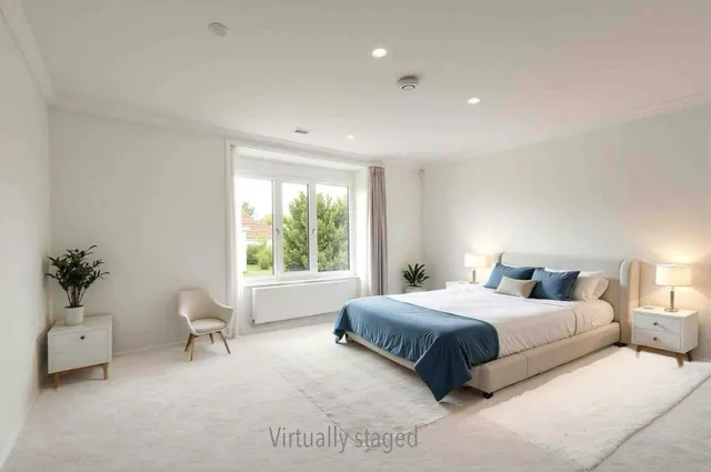 a bedroom with a large bed and a window