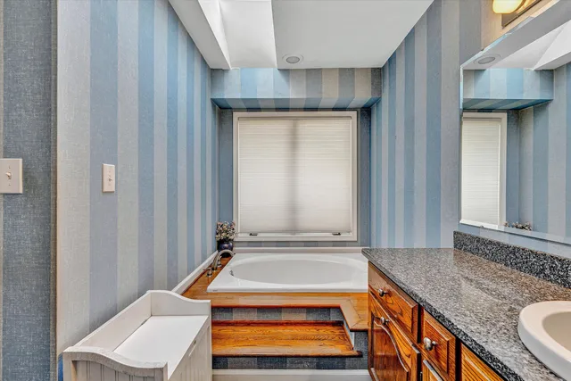 a room with pool table and windows