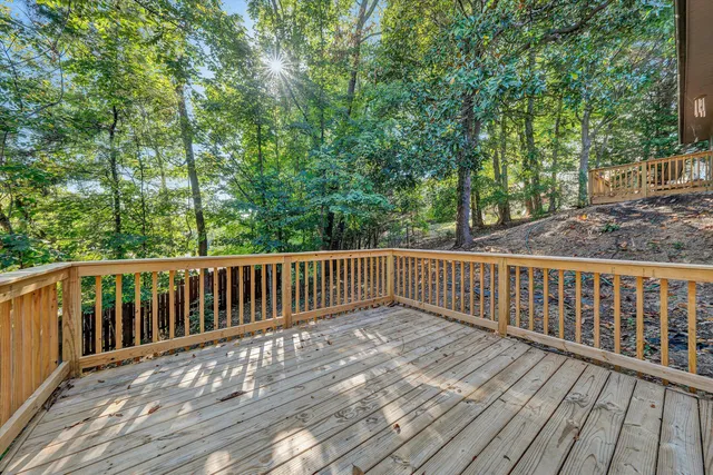 a view of balcony with wooden floor and fence