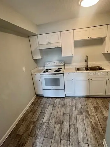 a kitchen with a sink and cabinets