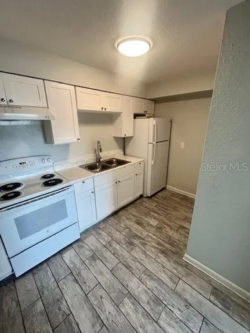 a kitchen with a sink and cabinets