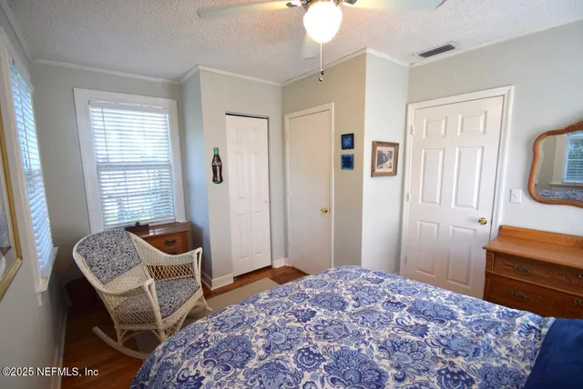 a bedroom with a bed and a dresser in it