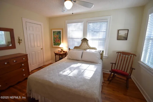 a bed room with a bed and a chair